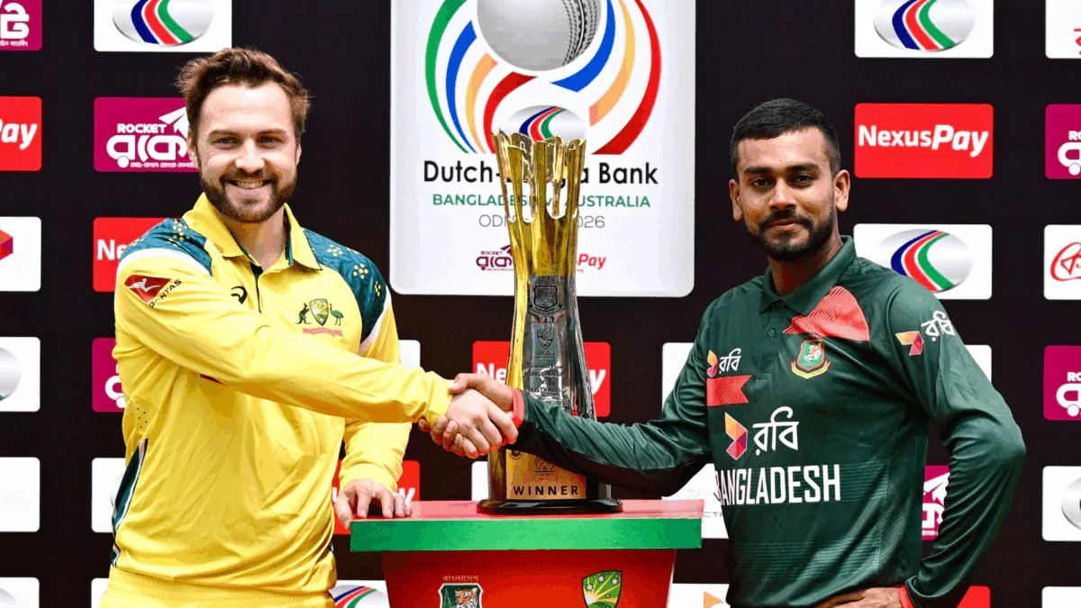 Australia and Bangladesh players during an international cricket match with fans, floodlights, and a packed stadium creating an intense atmosphere.