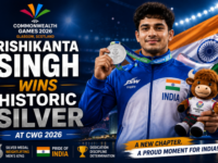 Indian weightlifter Rishikanta Singh celebrating his silver medal on the podium at Glasgow 2026.