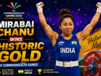 Mirabai Chanu celebrating with her gold medal on the podium at the Commonwealth Games.